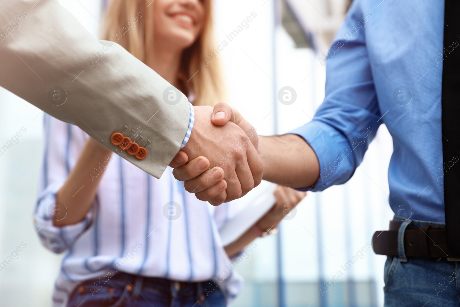 Photo of Business partners shaking hands after meeting, closeup