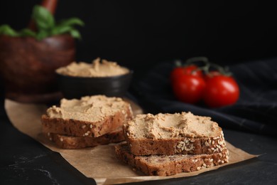 Fresh bread with delicious meat pate served on black table, closeup