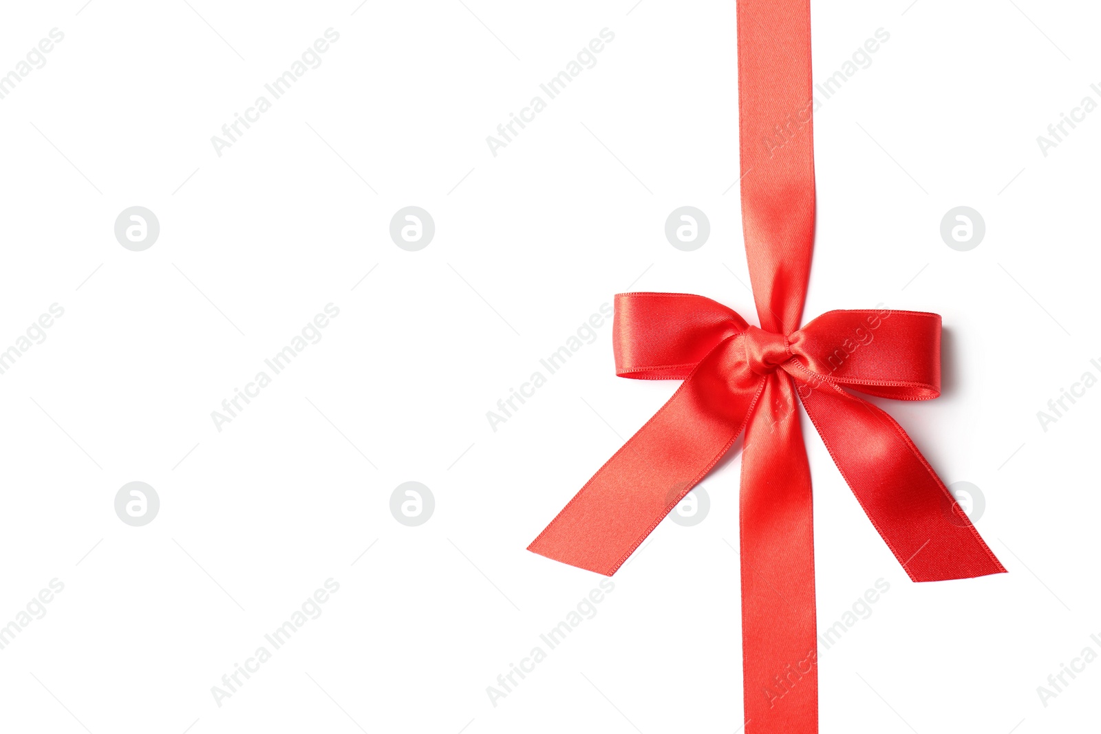 Photo of Red ribbon with bow on white background. Festive decoration