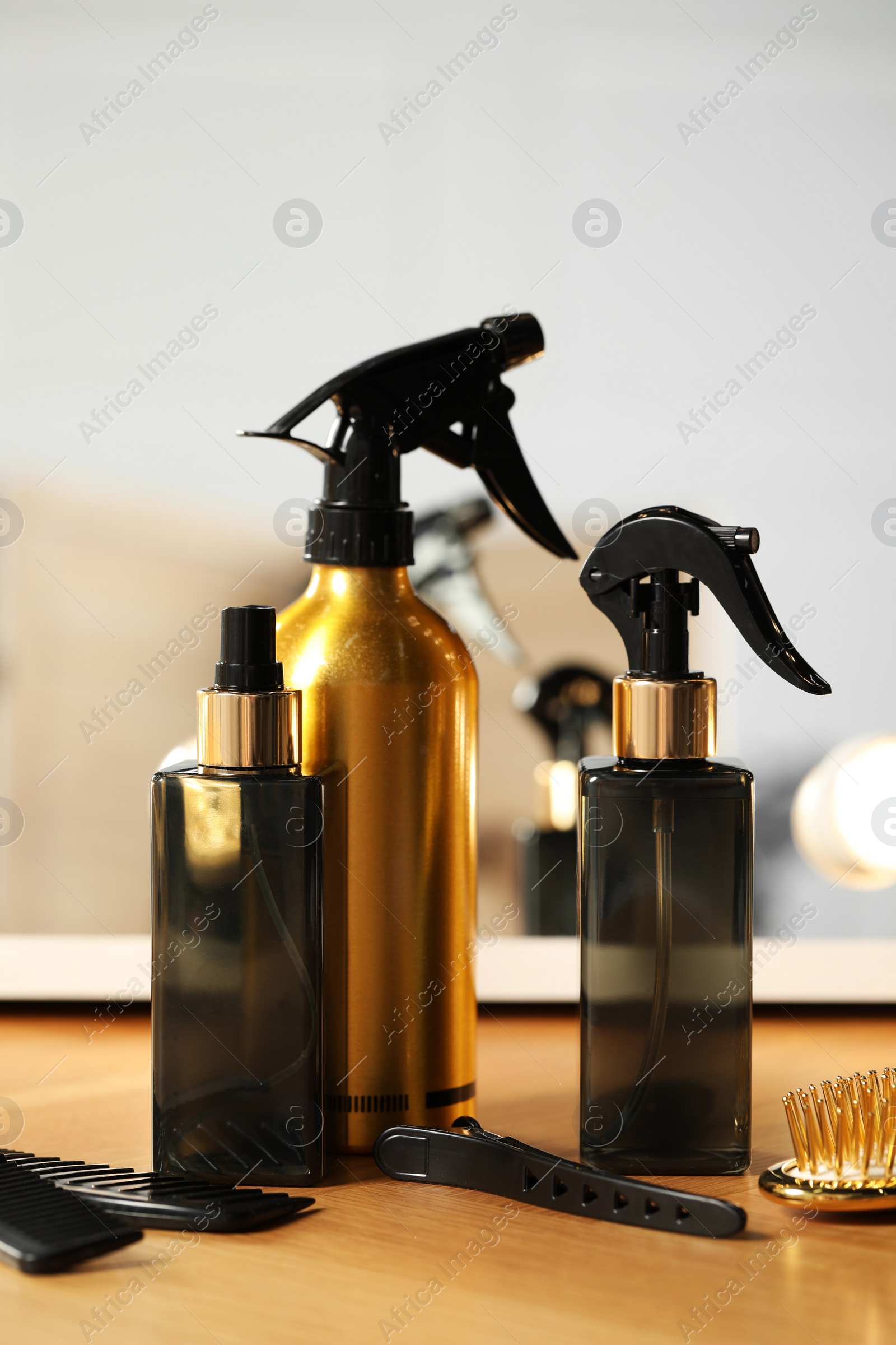 Photo of Set of hairdresser tools on table in salon