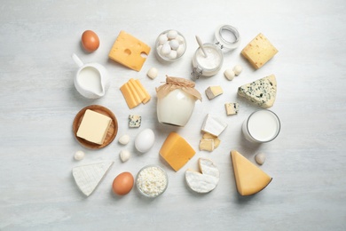 Different delicious dairy products on white table, flat lay