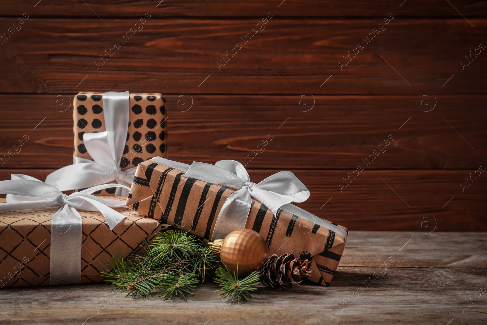 Photo of Beautiful composition with gift box and Christmas decorations on wooden table