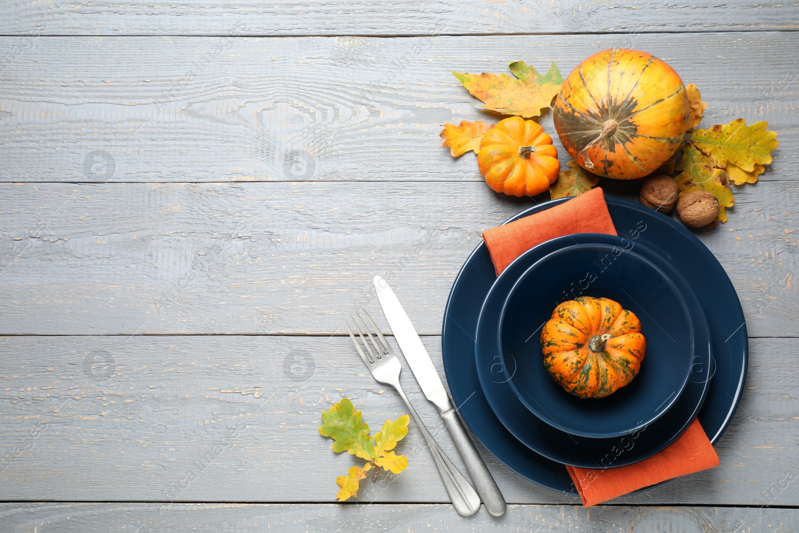 Photo of Festive table setting on light wooden background, flat lay with space for text. Thanksgiving Day celebration