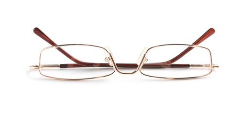 Photo of Glasses with corrective lenses on white background. Vision problem
