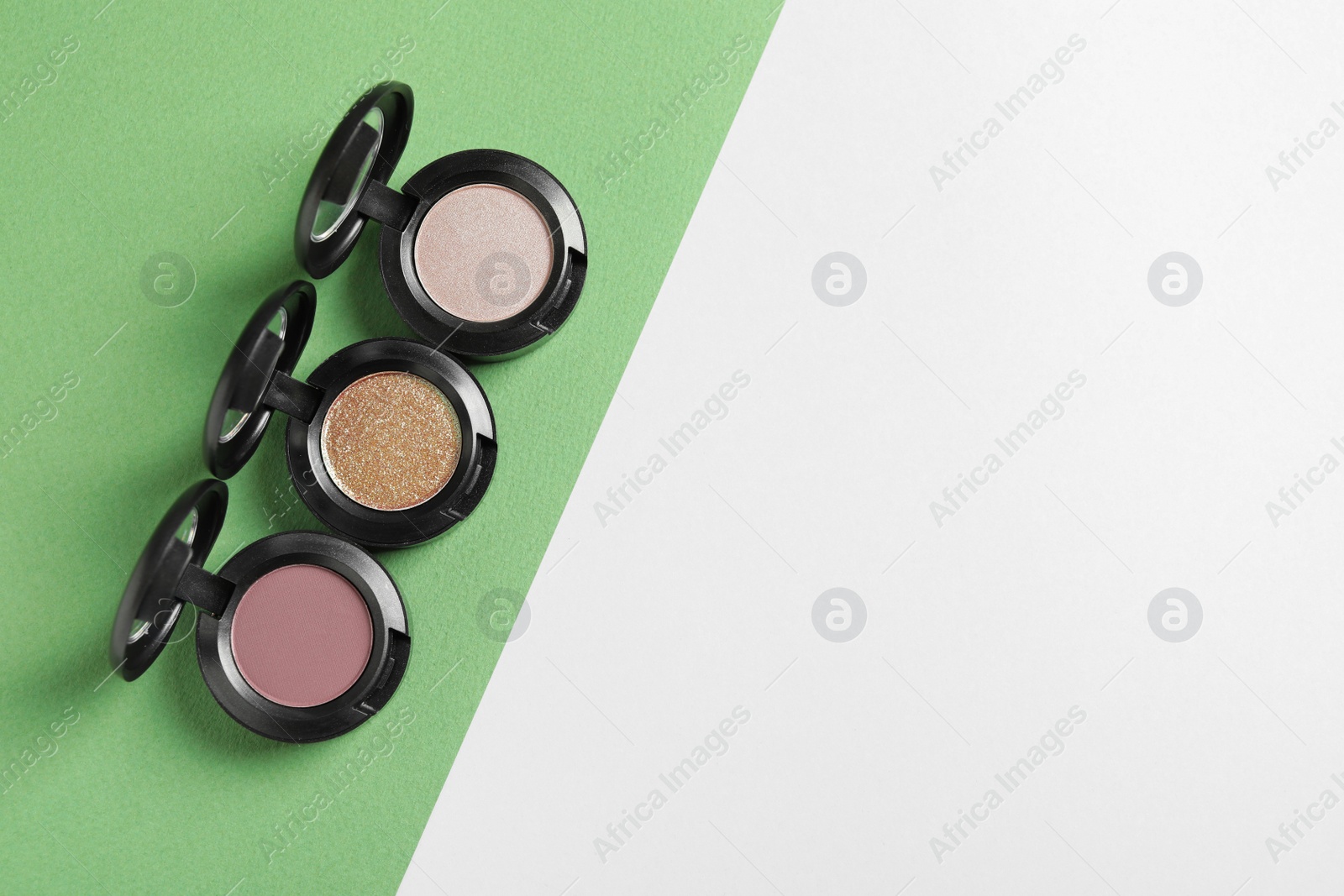 Photo of Flat lay composition with different eye shadows on color background. Space for text