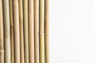 Photo of Dry bamboo sticks on white background, top view