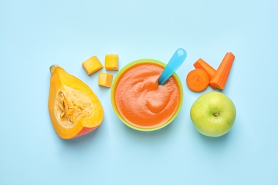 Photo of Healthy baby food and ingredients on light blue background, flat lay