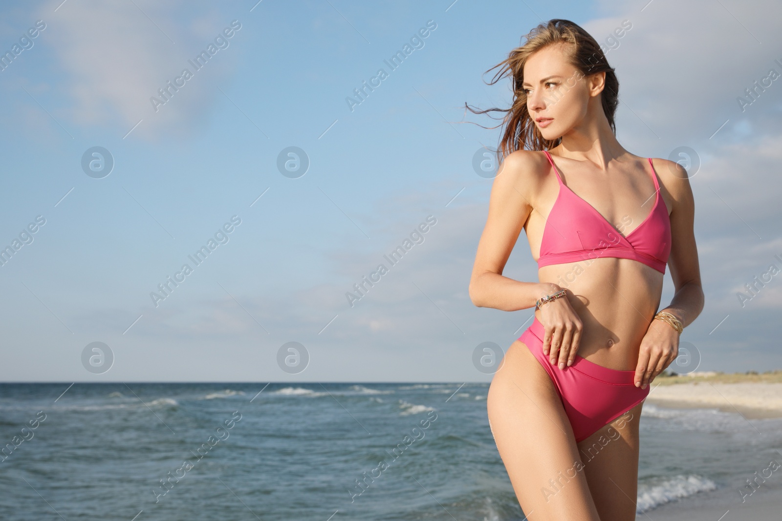 Photo of Attractive woman with beautiful body in bikini near sea. Space for text