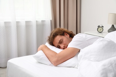 Handsome young man sleeping on pillow at home. Bedtime