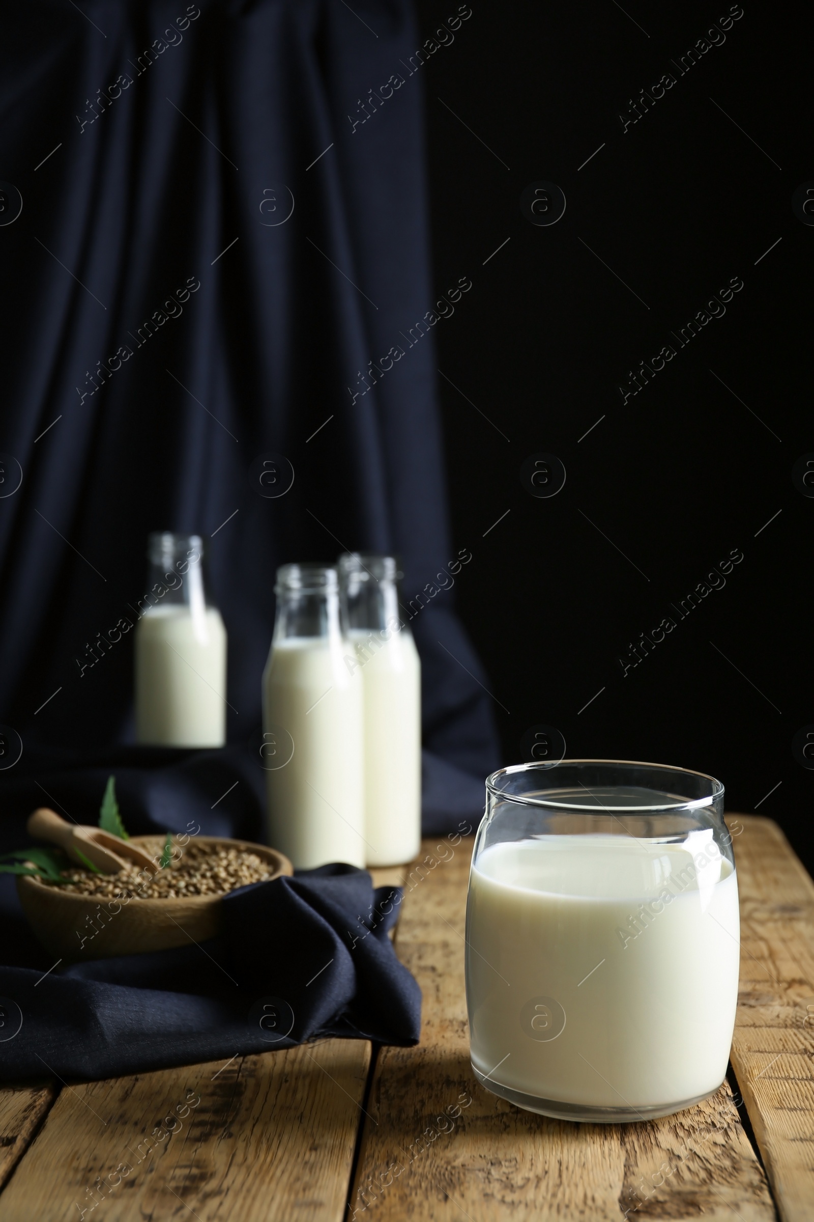 Photo of Jar of hemp milk on wooden table