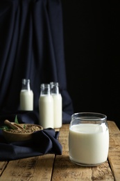 Photo of Jar of hemp milk on wooden table