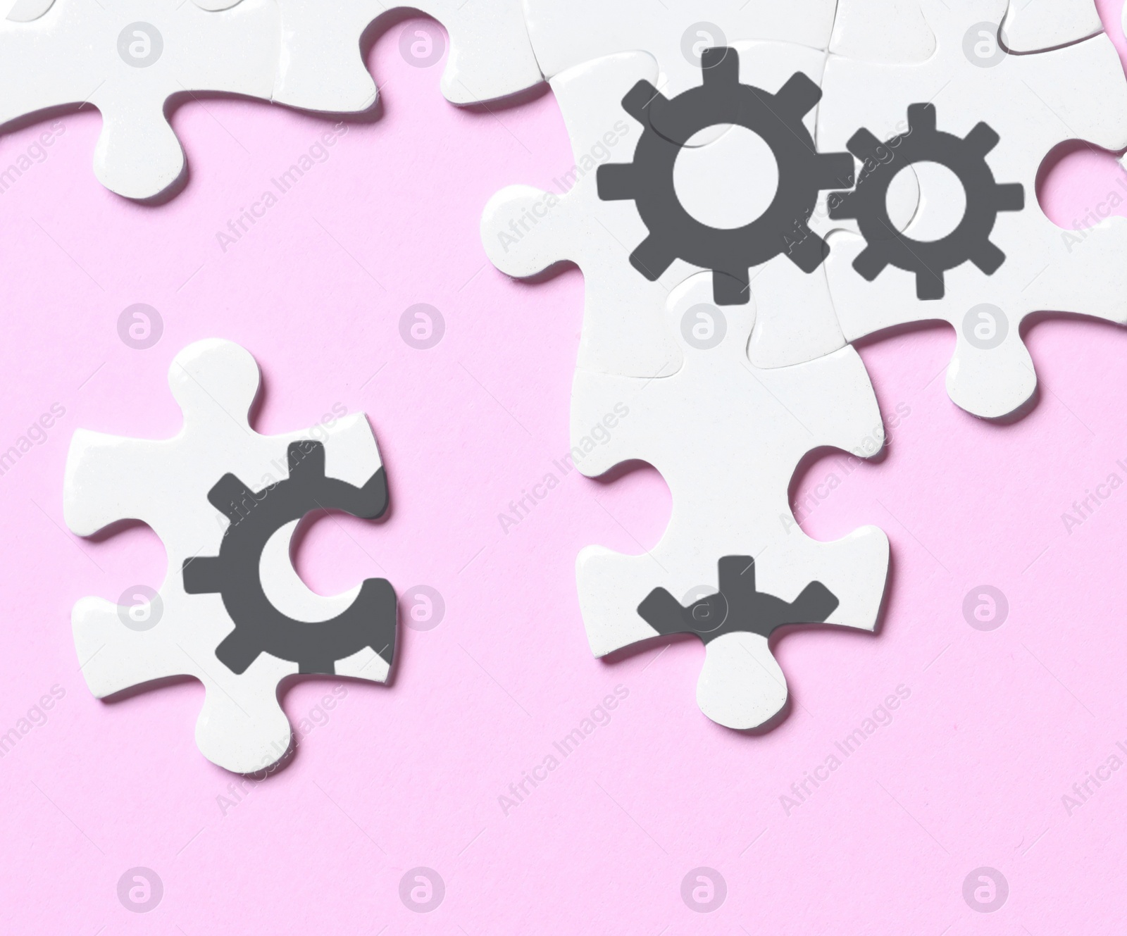 Image of Teamwork concept. White puzzle pieces on pink background, flat lay 