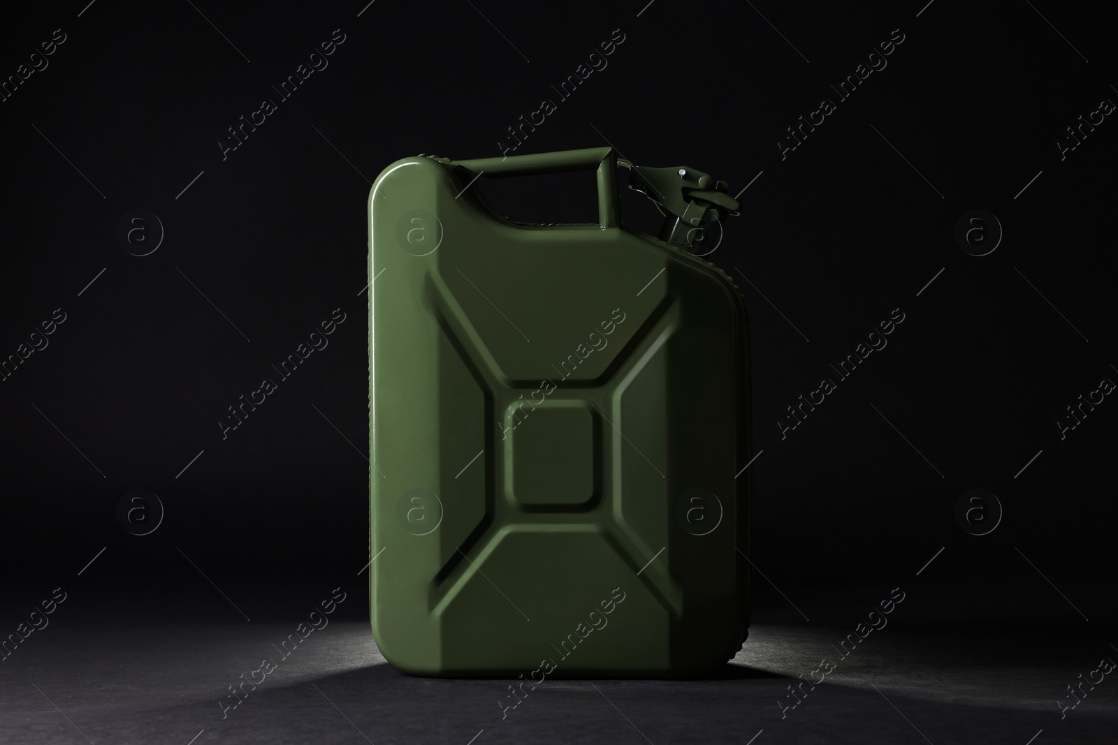 Photo of New khaki metal canister on black background