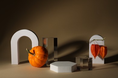 Stylish presentation for product. Autumn composition with decorative pumpkin and geometric figures on brown background