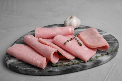 Photo of Tasty fresh ham served on light grey table