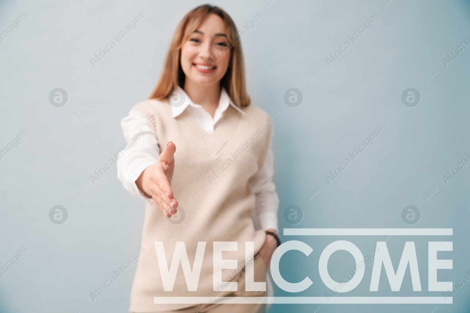 Image of Happy young woman offering handshake on light background, focus on hand. Welcome to team