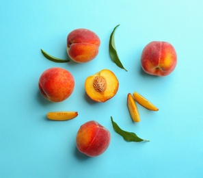 Flat lay composition with fresh peaches on blue background