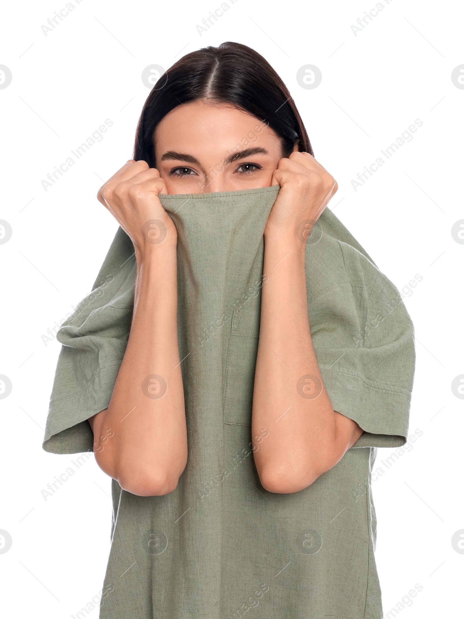 Photo of Embarrassed young woman covering face with shirt on white background