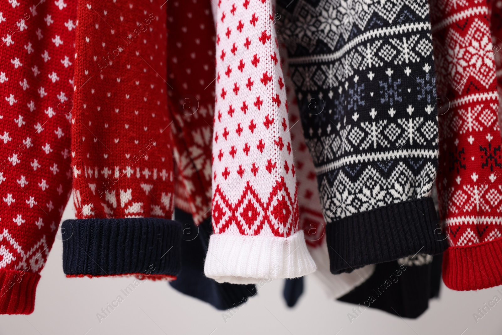 Photo of Closeup view of many different Christmas sweaters