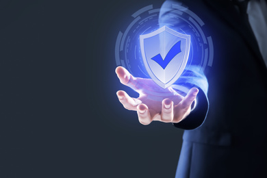 Image of Cyber insurance concept. Man demonstrating shield illustration as symbol of protection, closeup