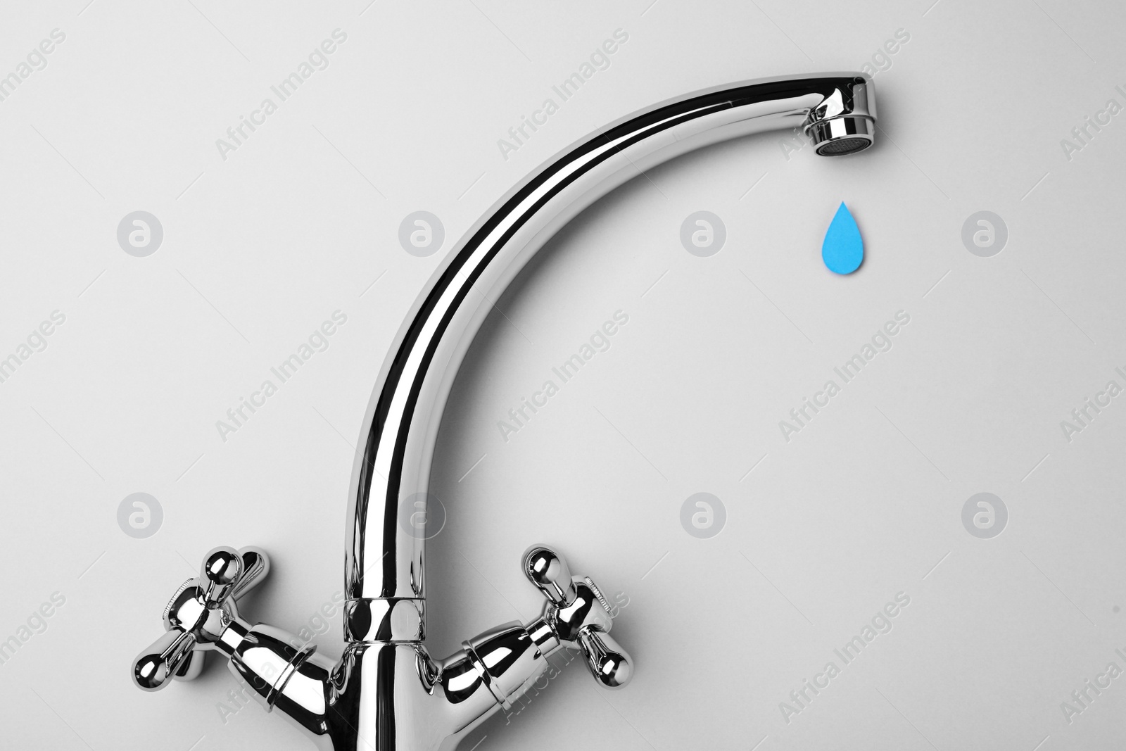 Photo of Paper water drop and modern faucet on grey background, flat lay