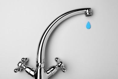 Photo of Paper water drop and modern faucet on grey background, flat lay