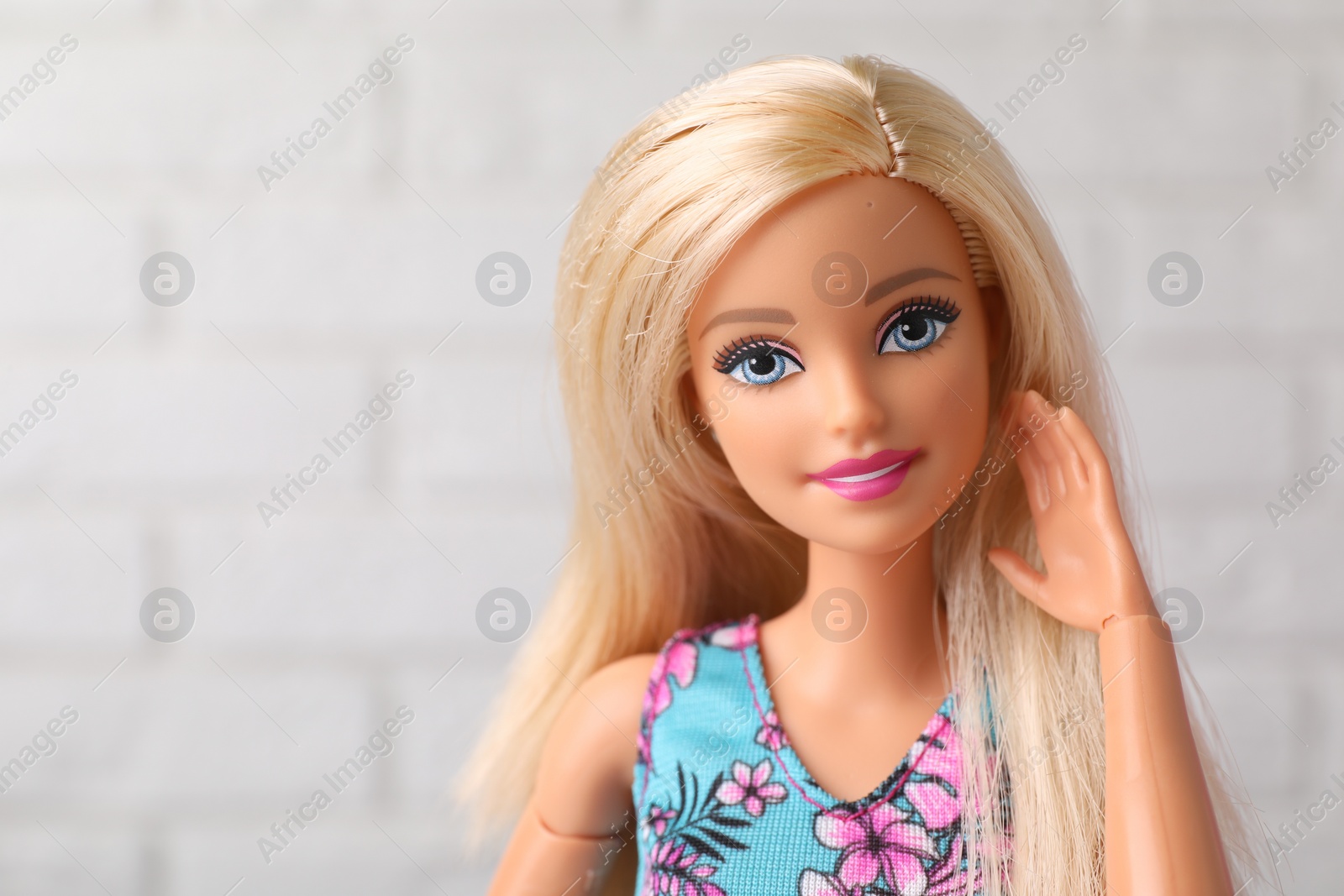 Photo of Mykolaiv, Ukraine - September 4, 2023: Beautiful Barbie doll near white brick wall, space for text