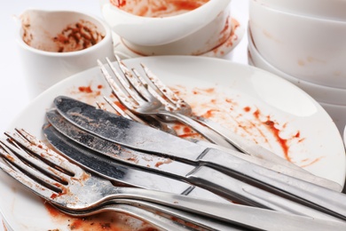 Photo of Pile of dirty dishes and cutlery, closeup