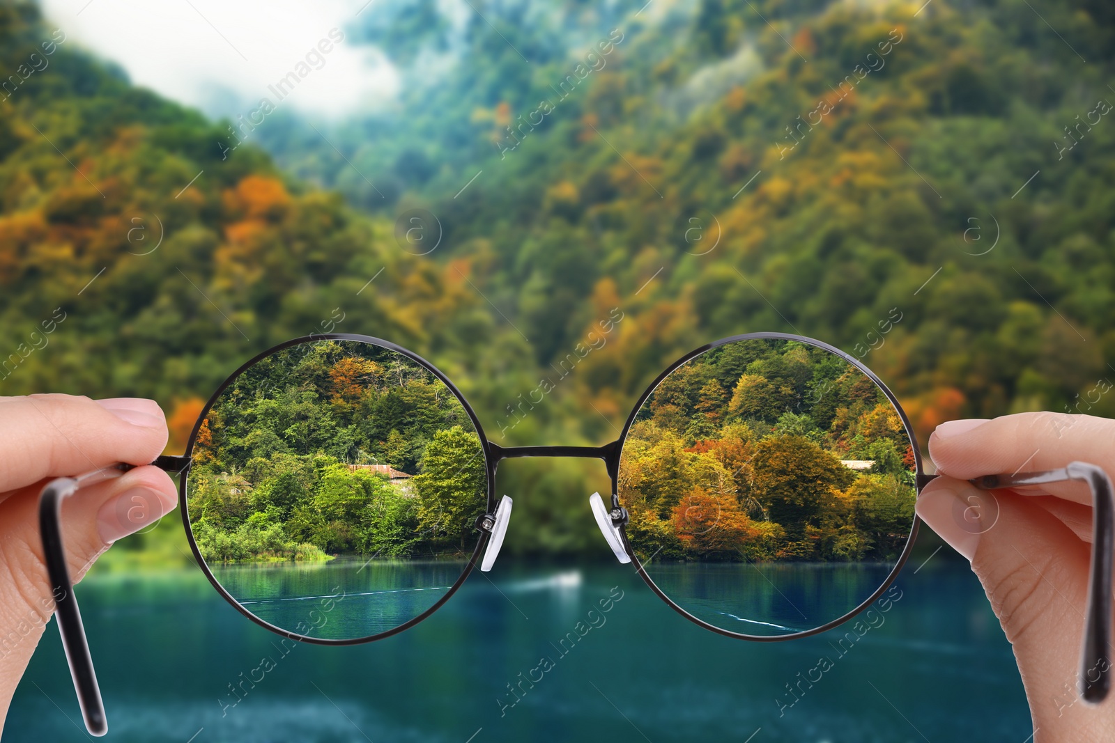 Image of Vision correction. Woman looking through glasses and seeing landscape clearer