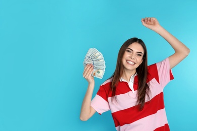 Young woman with money on color background. Space for text