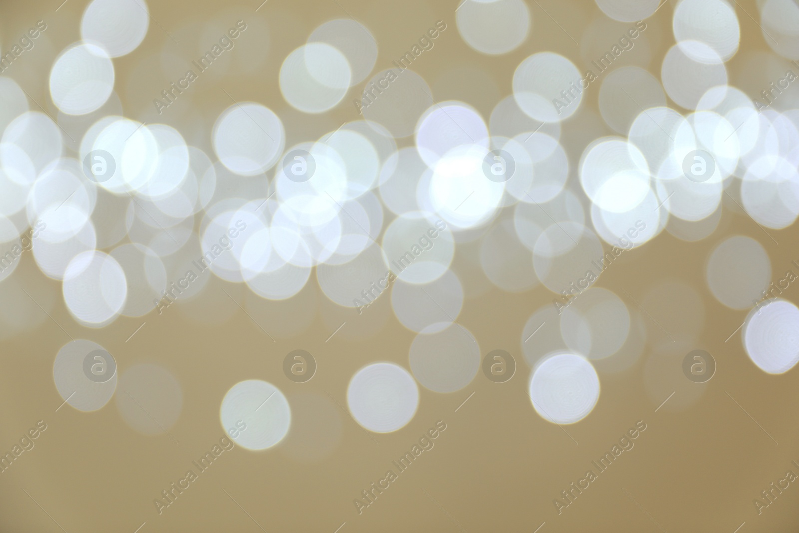 Photo of Blurred view of shiny silver lights. Bokeh effect