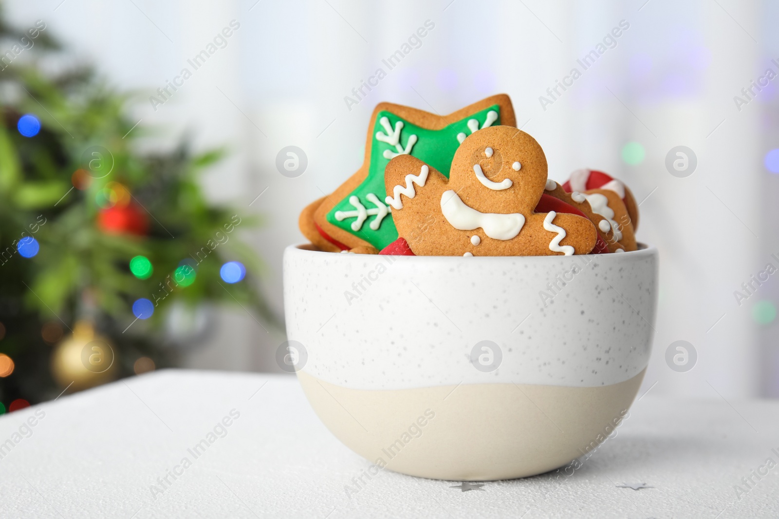 Photo of Bowl with tasty homemade Christmas cookies on table