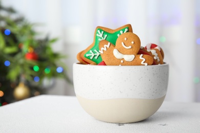 Photo of Bowl with tasty homemade Christmas cookies on table