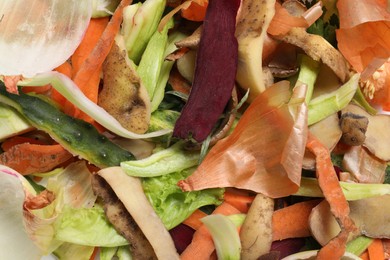 Photo of Peels of fresh vegetables as background, flat lay