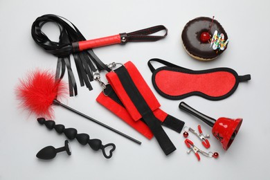 Flat lay composition with sex toys on white background