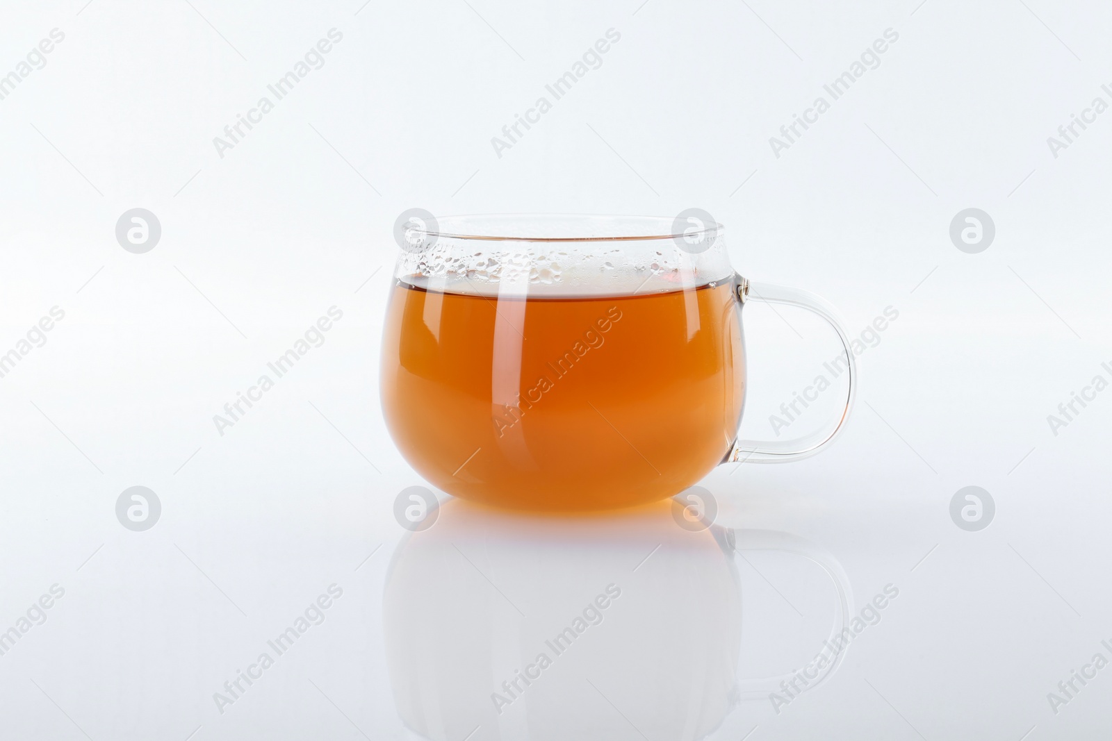 Photo of Tasty tea in cup on white background