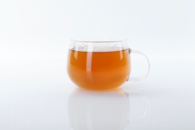 Tasty tea in cup on white background