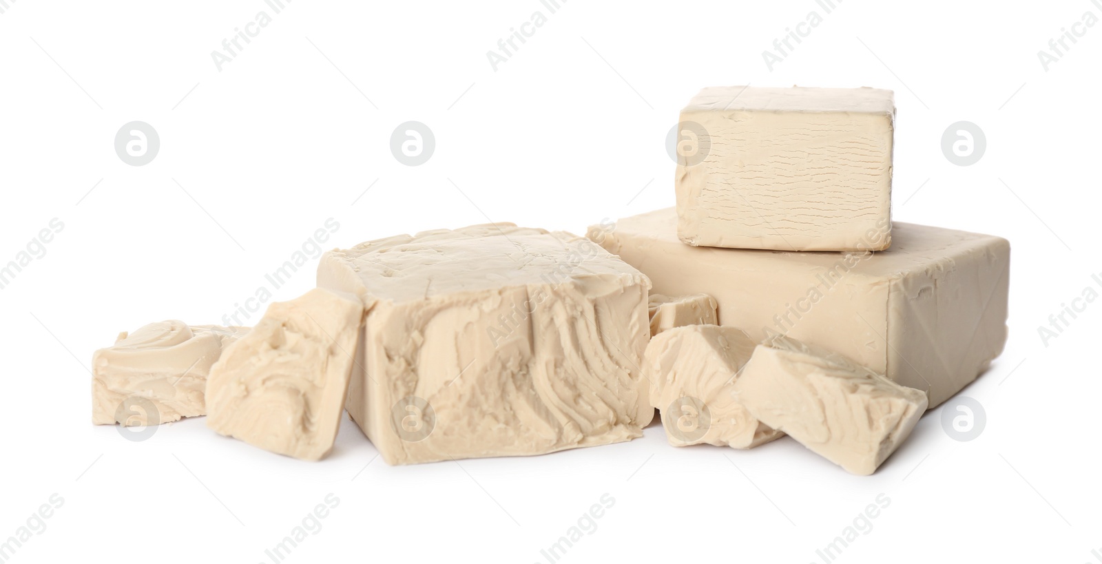 Photo of Pieces of compressed yeast on white background