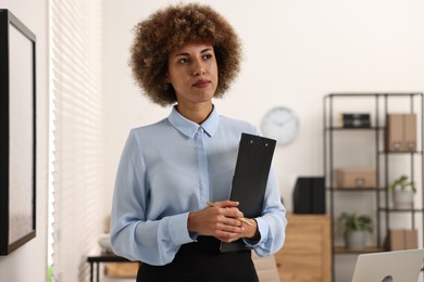 Notary with clipboard and pen in office