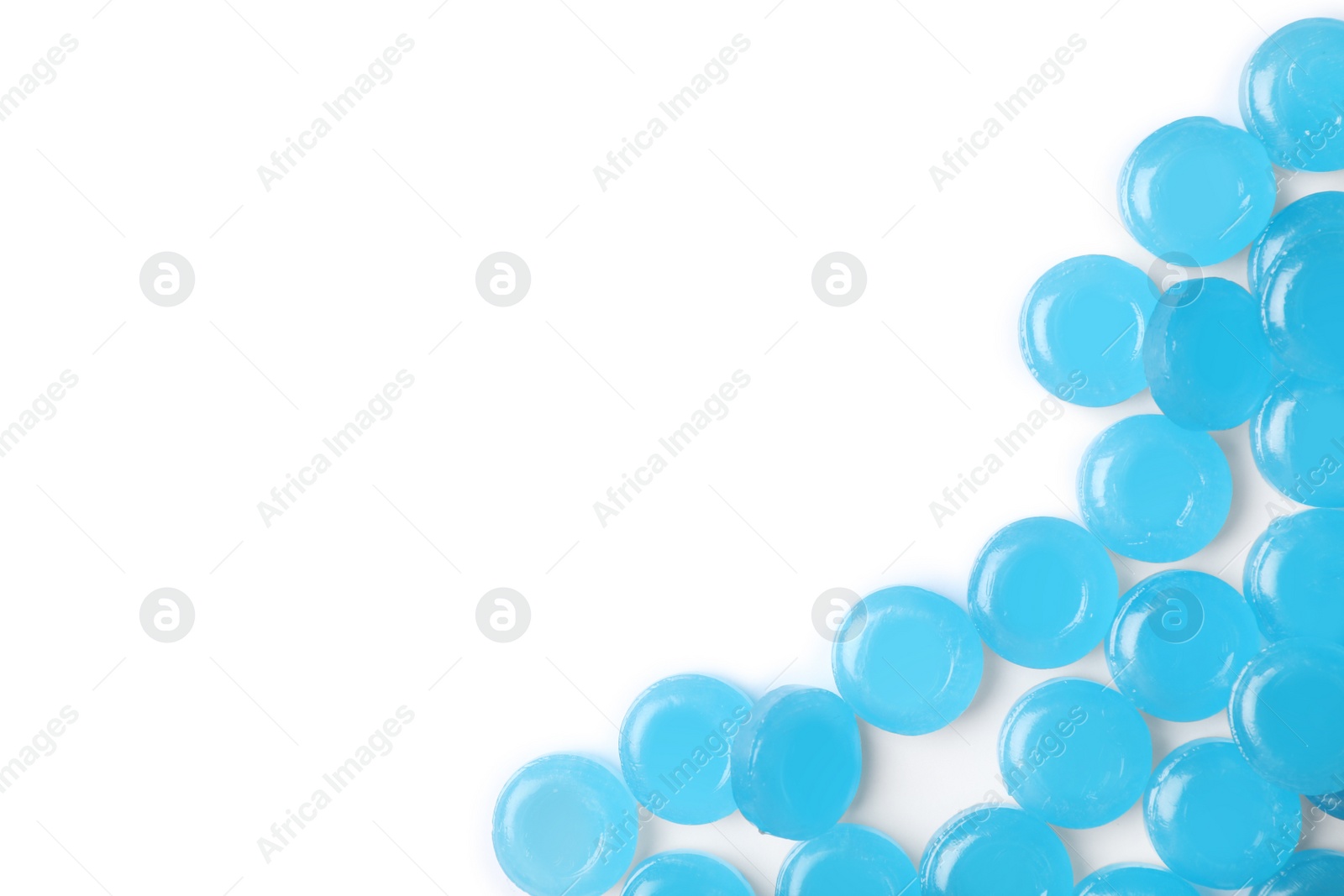 Photo of Color cough drops on white background. Top view with space for text