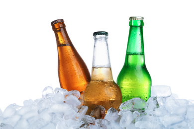 Photo of Ice cubes and different bottles on white background