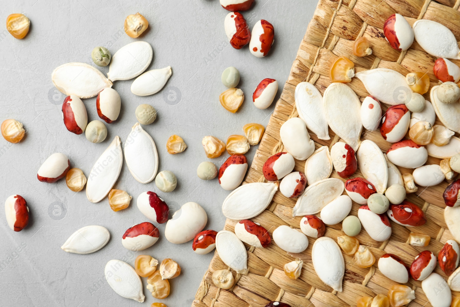 Photo of Mixed vegetable seeds on grey background, flat lay