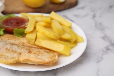 Photo of Delicious fish and chips with ketchup and lettuce on light table, closeup