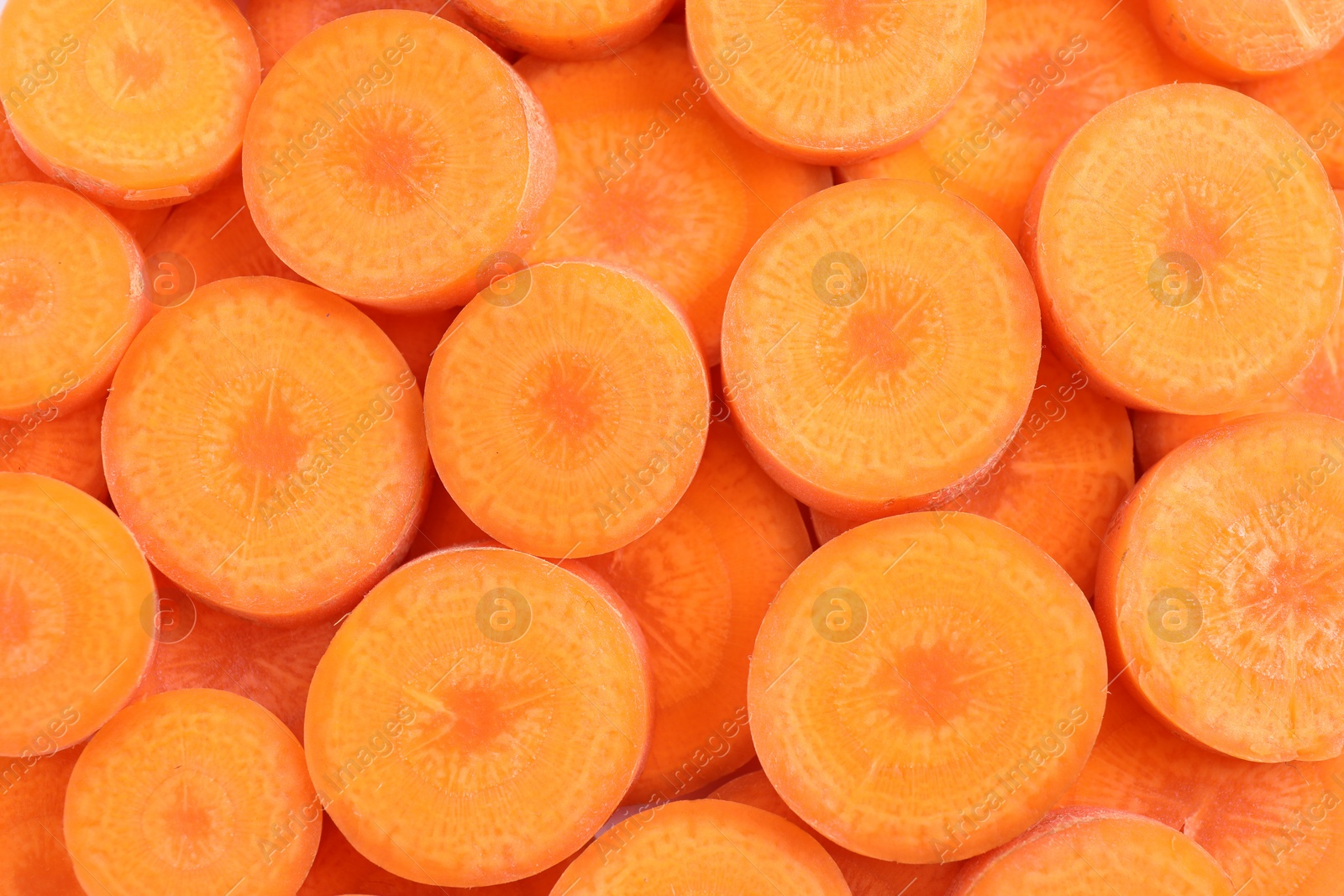 Slices of fresh ripe carrot as background, top view Photo of Slices of fresh ripe carrot as background, top view