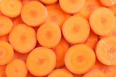 Photo of Slices of fresh ripe carrot as background, top view
