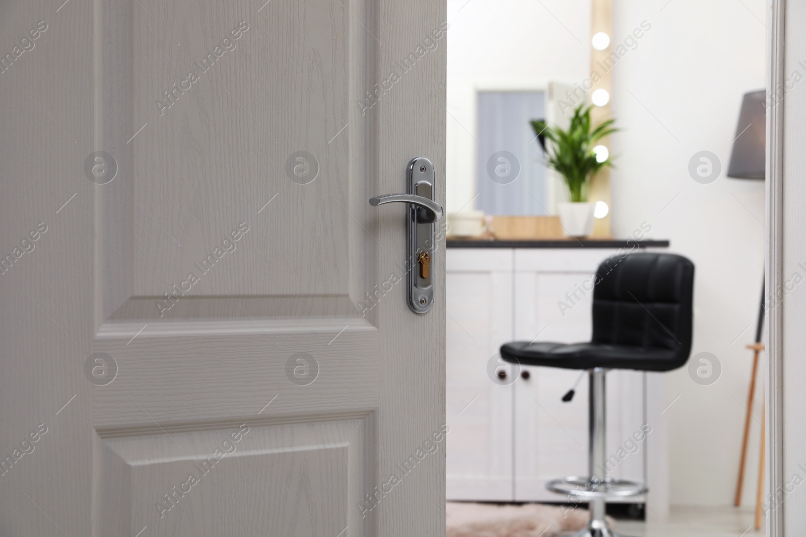 Photo of Closeup of open door in modern apartment