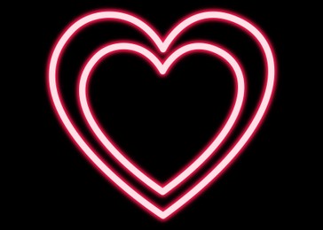 Hearts glowing neon sign on black background