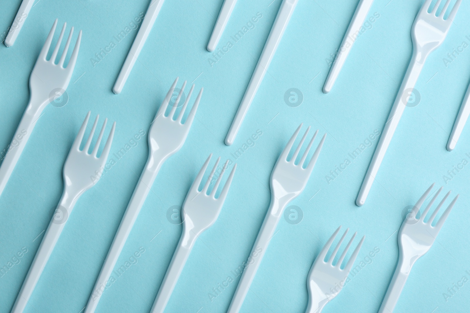 Photo of Flat lay composition with plastic forks on color background. Table setting