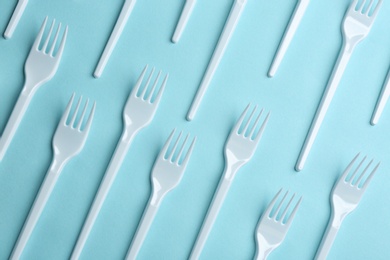 Flat lay composition with plastic forks on color background. Table setting