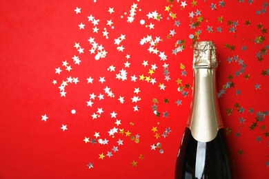 Photo of Creative flat lay composition with bottle of champagne and space for text on color background